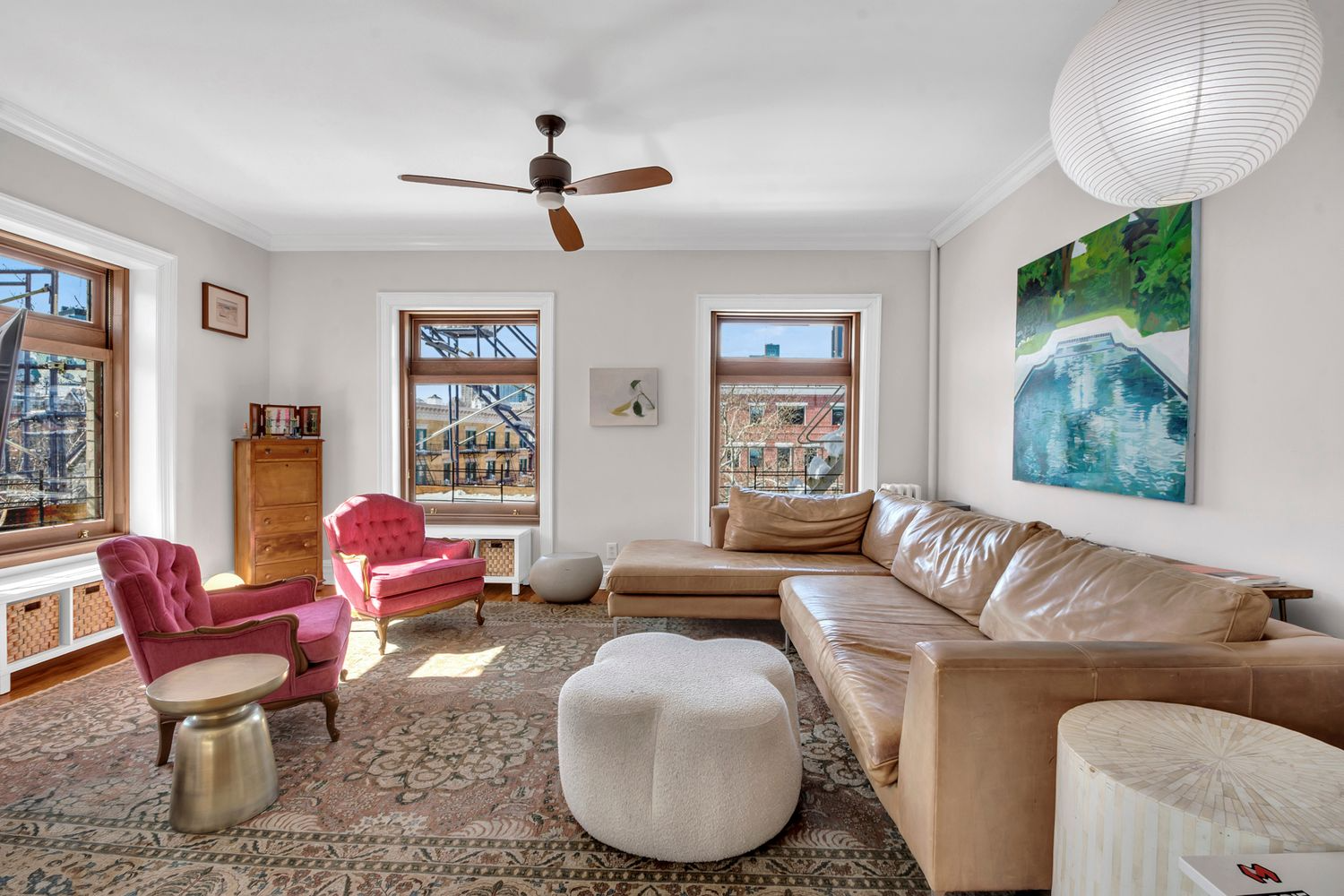 living room with white walls, ceiling fan