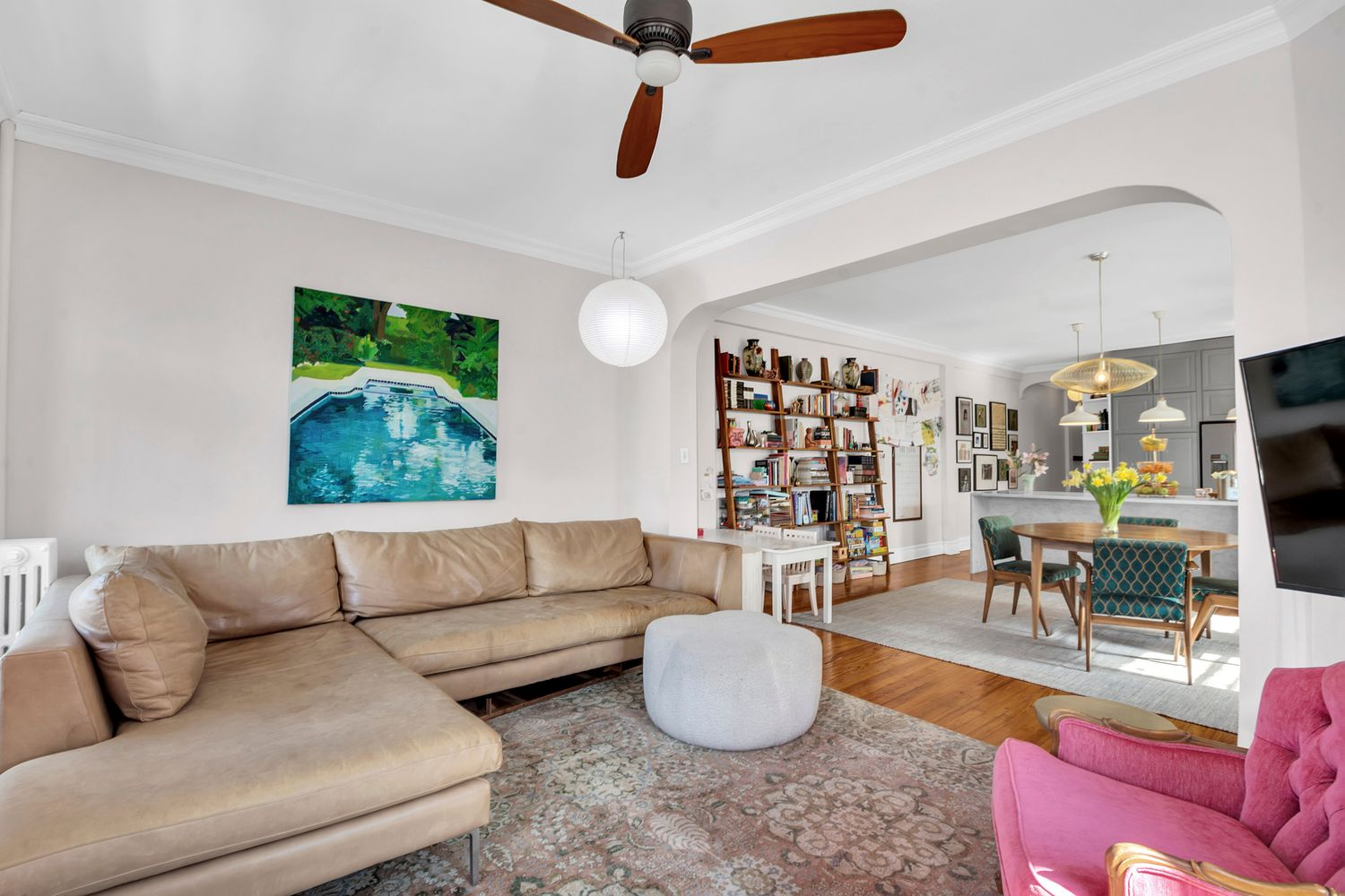 living room with arched doorway, ceiling fan