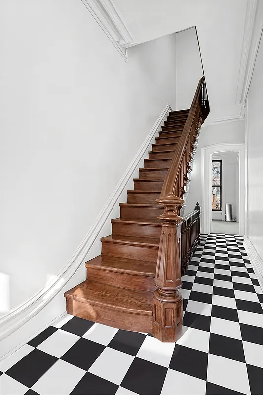 front entry with original stair, black and white floor tile