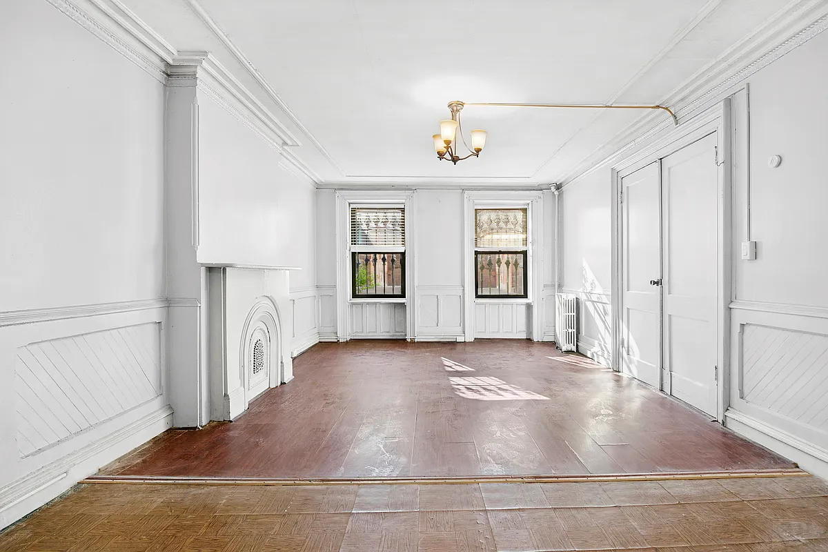 garden level dining room with mantel, wainscoting painted white