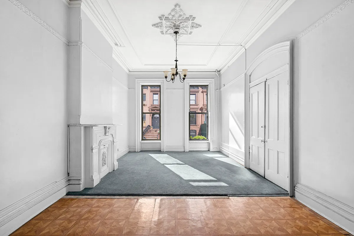 parlor with mantel, ceiling medallion, moldings