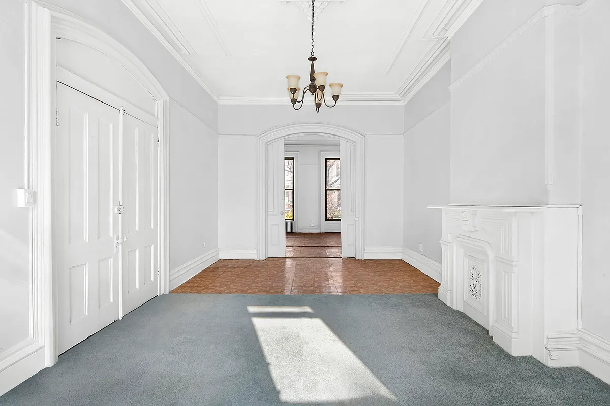 parlor with moldings, mantel painted white