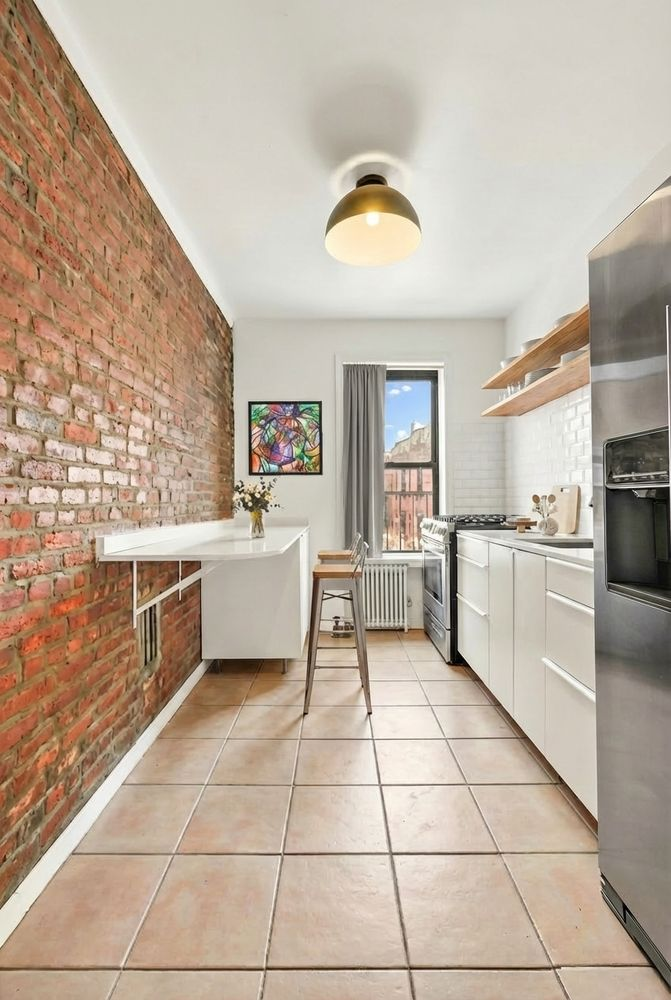 kitchen with tile floor, white cabinets