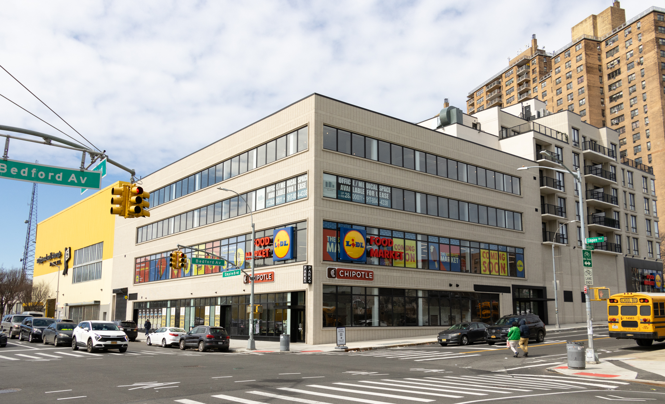 new building of light brick with a grocery store