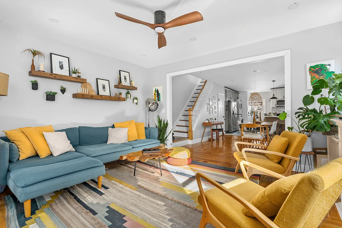living room with view into an open plan kitchen and dining room