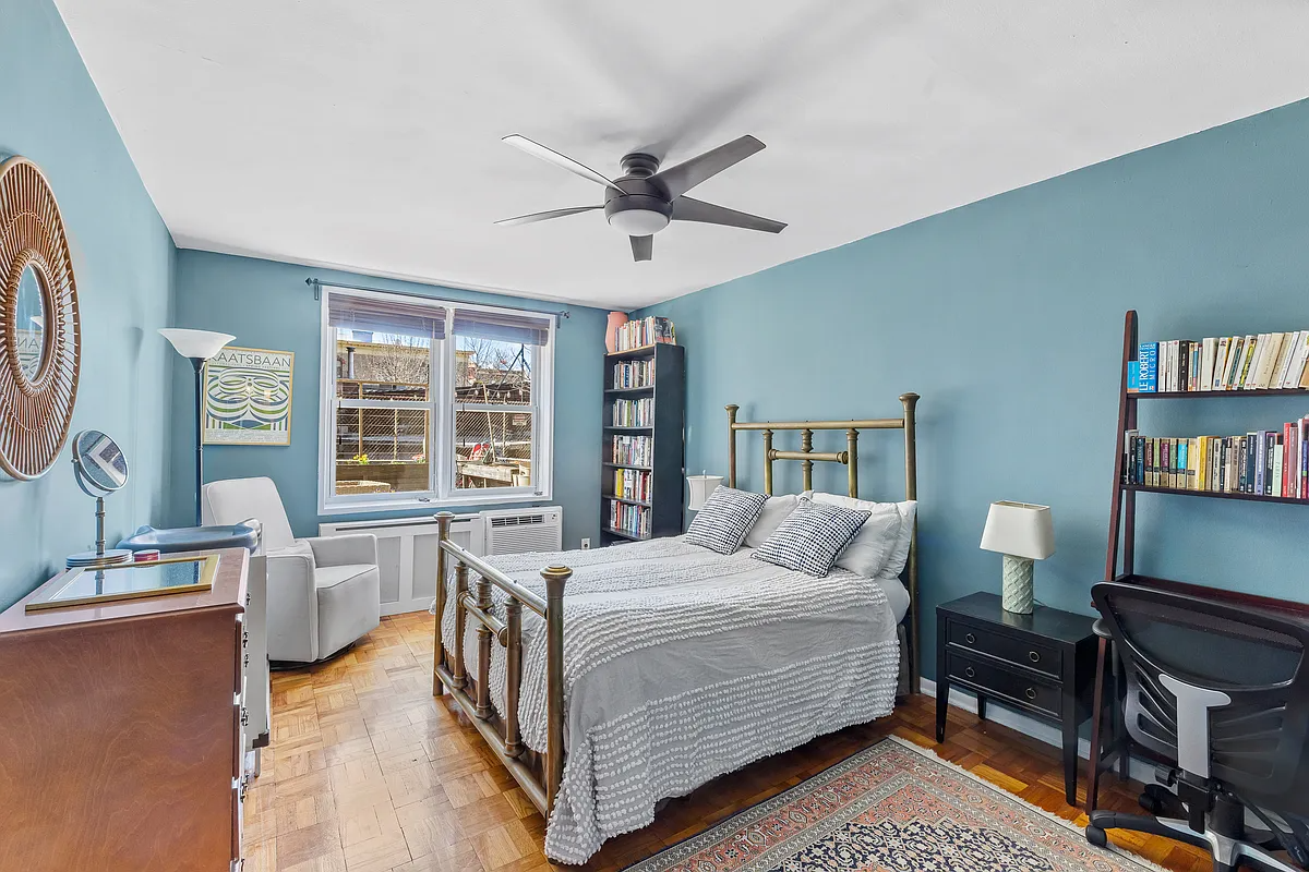 bedroom with blue walls, ceiling fan
