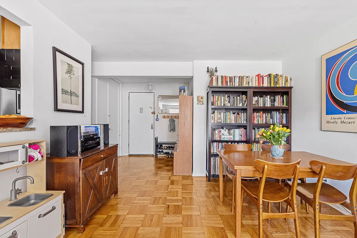 living room with view to a foyer with room for bookshelves