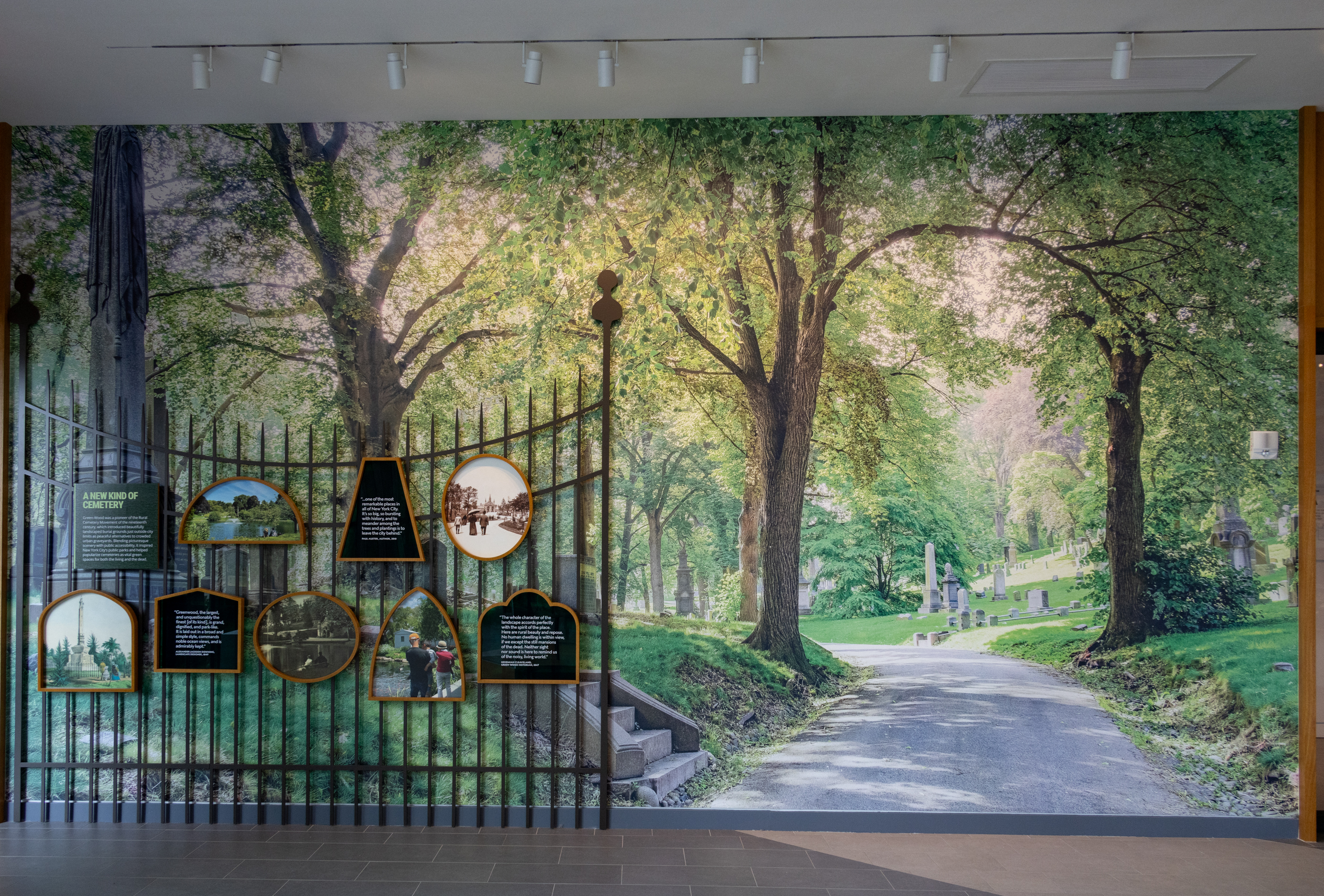 a wall with a photo mural of the green-wood cemetery