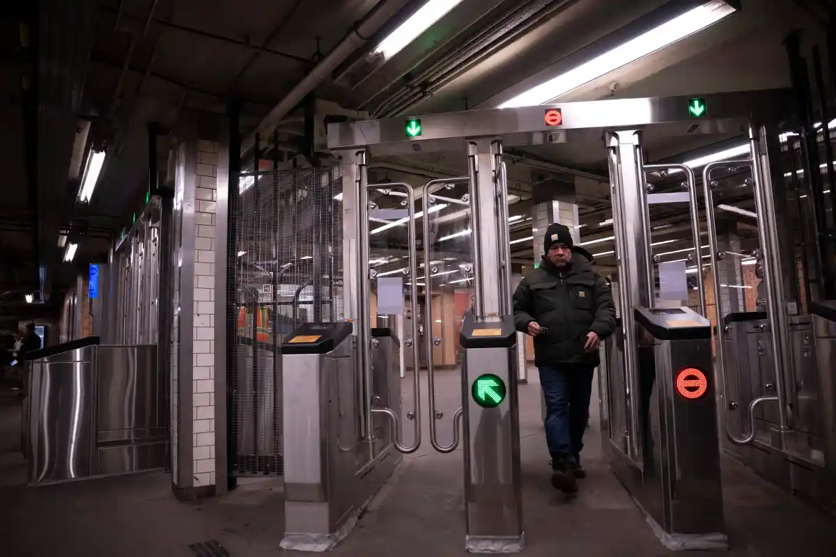 a person goes through security gates at a subway station