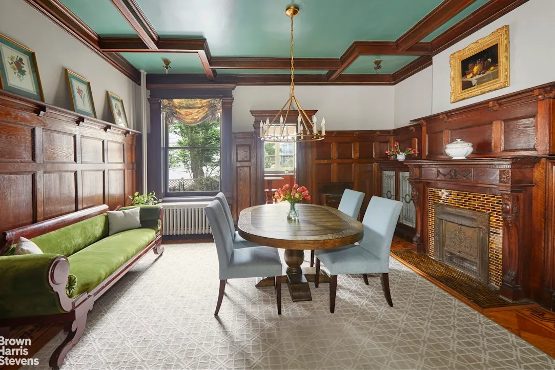 dining room with wainscoting, coffered ceiling, built-in bookshelves