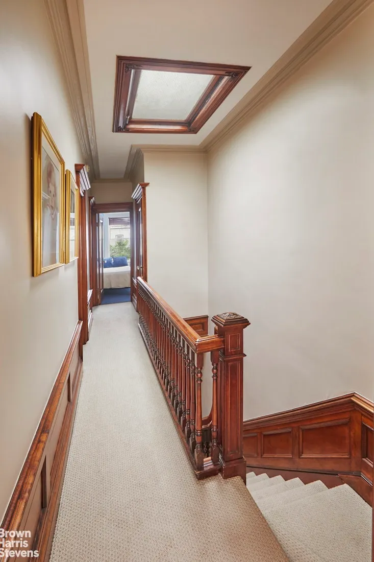 top floor hallway with carpet, skylight