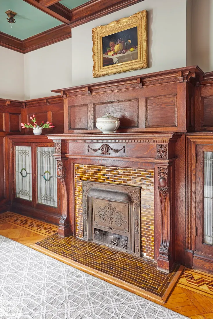 dining room with built-in bookshelves on either side of the mantel