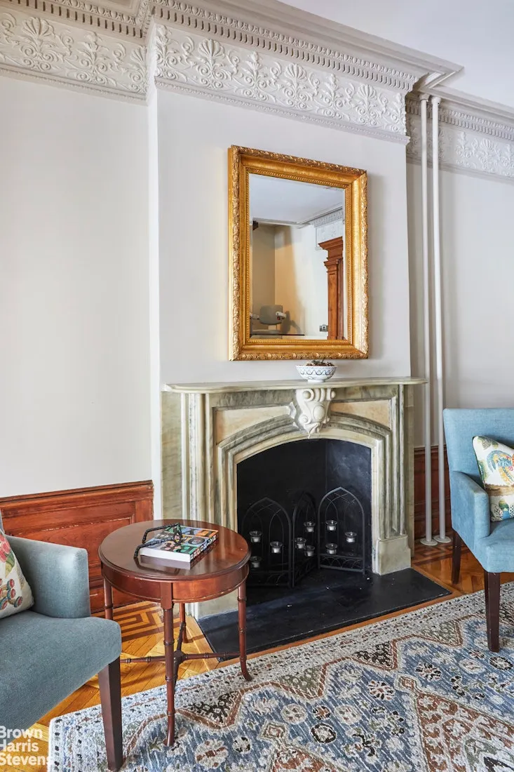 parlor with marble mantel and plasterwork