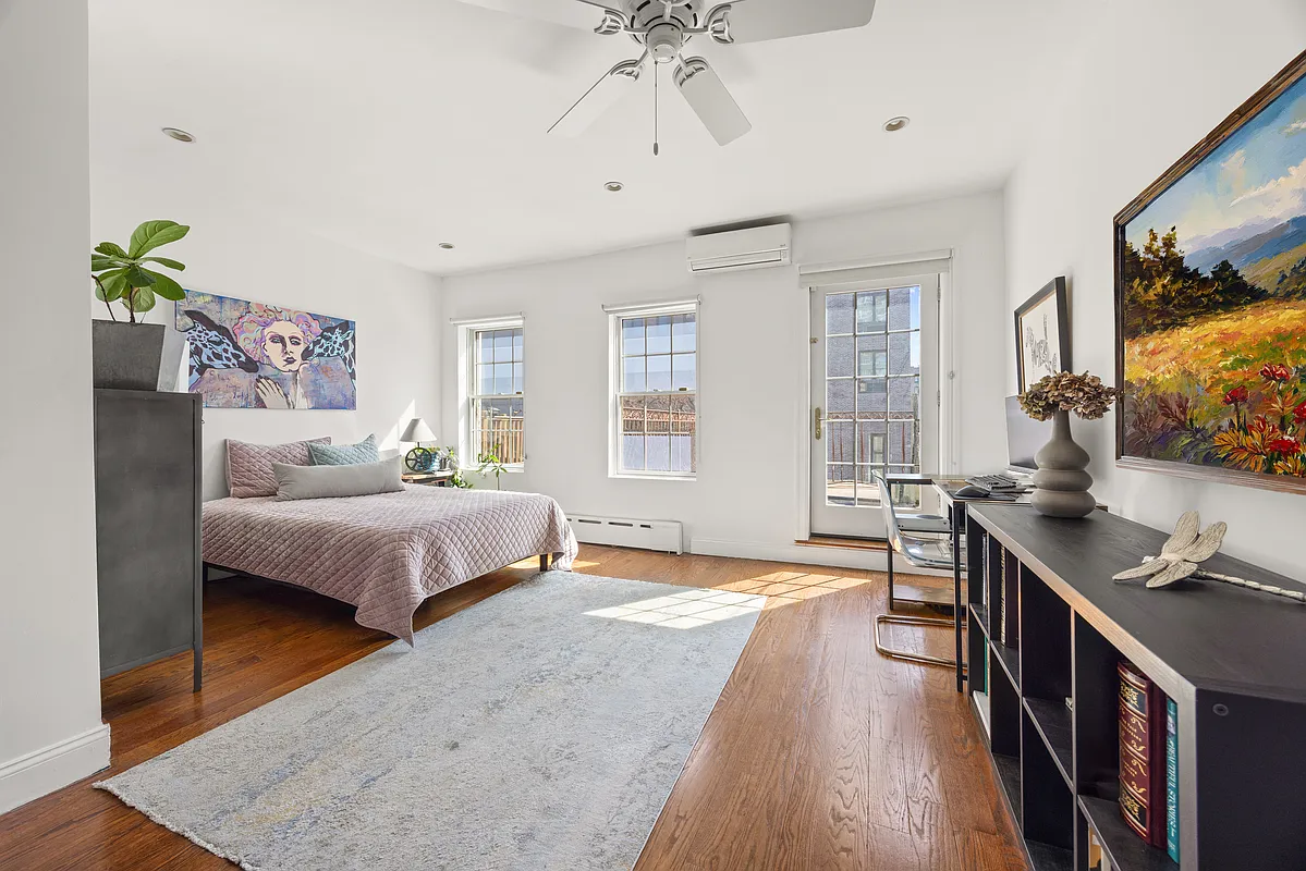 bedroom with white walls, ceiling fan, wood floor