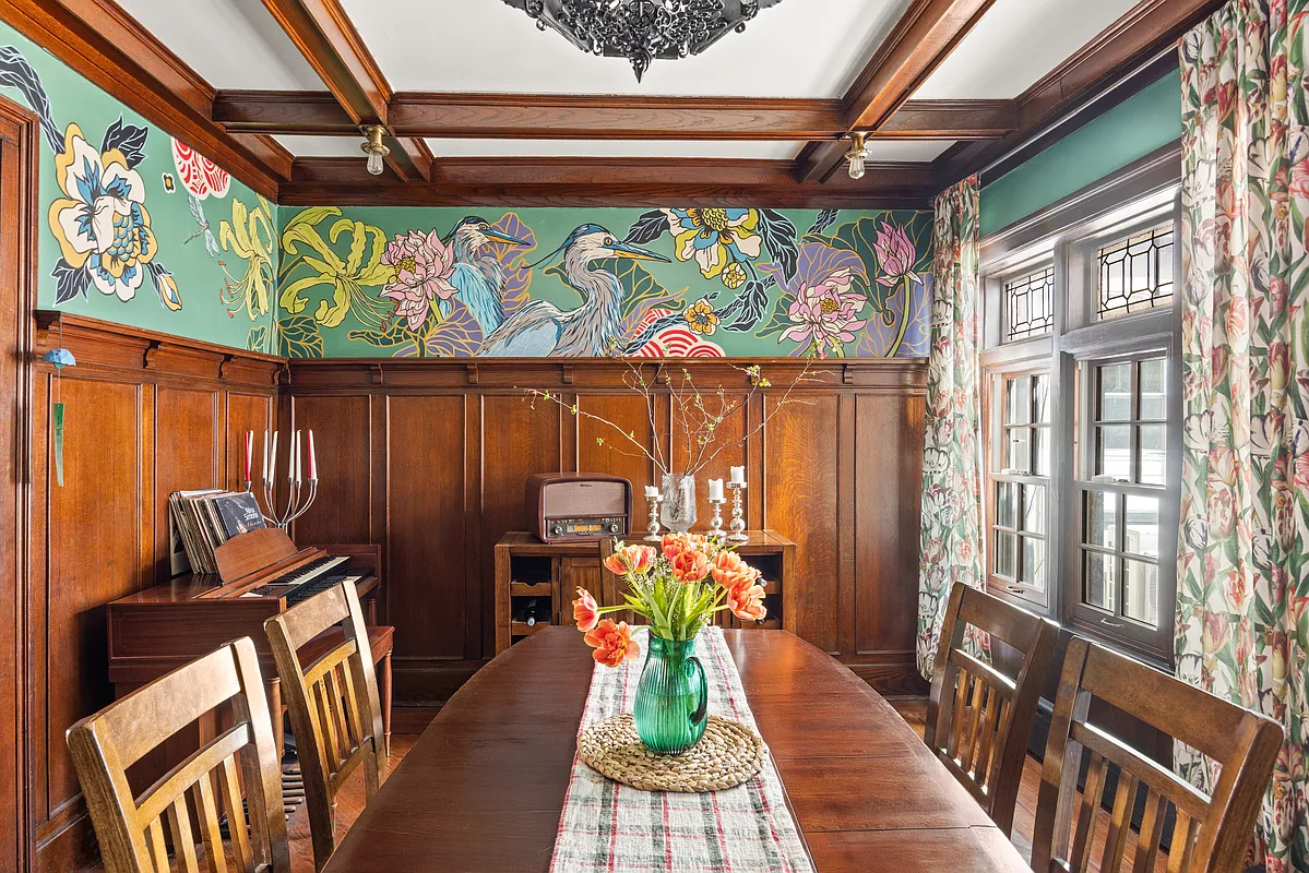 dining room with wainscoting, beamed ceiling