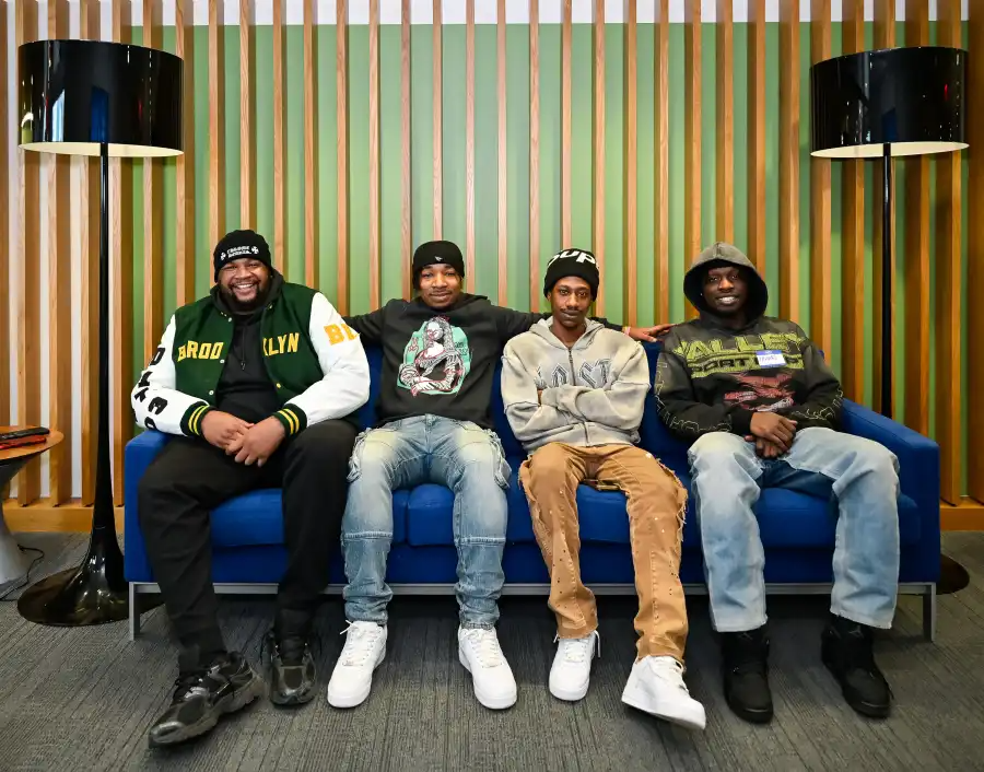 group sitting on a sofa and smiling for the camera