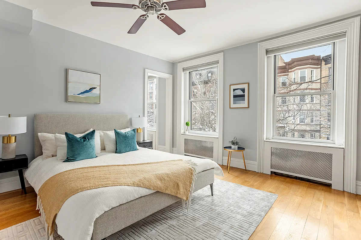 bedroom with two windows, ceiling fan,