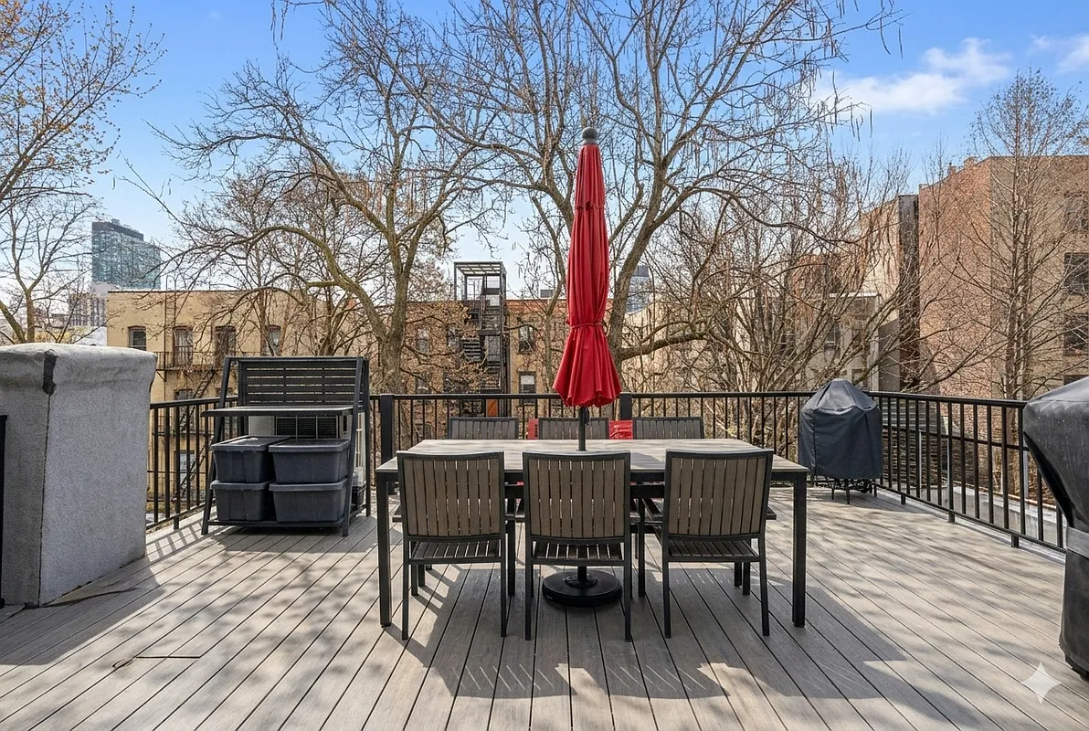 deck with an iron railing and room for dining