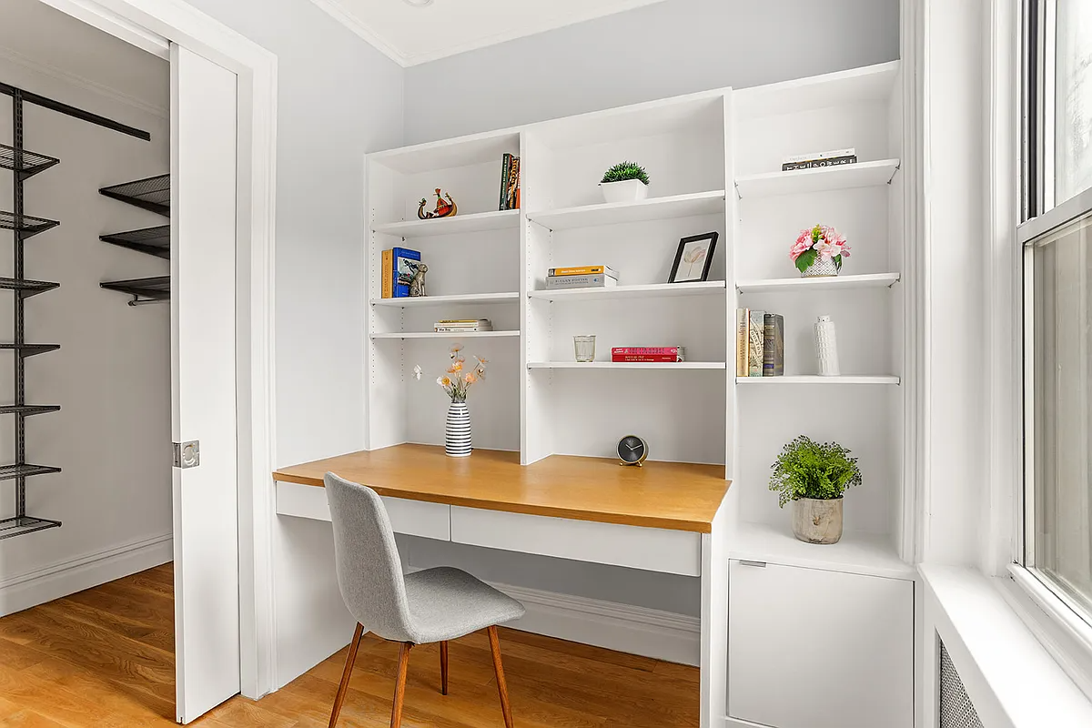 an office with a pocketoor and built-in desk