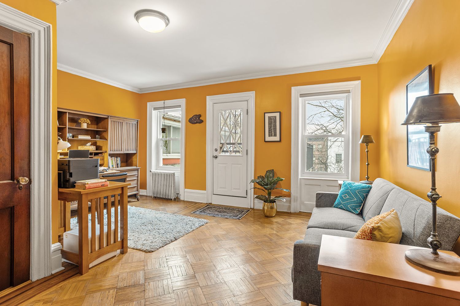 bedroom set up as an office space with access to a rear deck