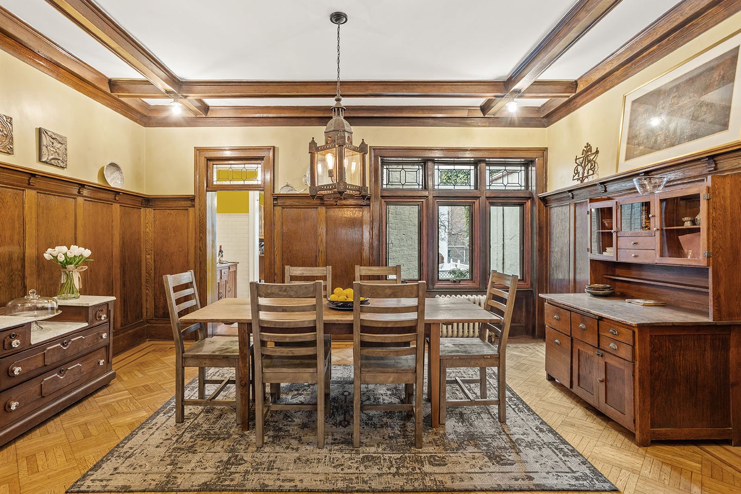 dining room with wainscoting, beamed ceiling,