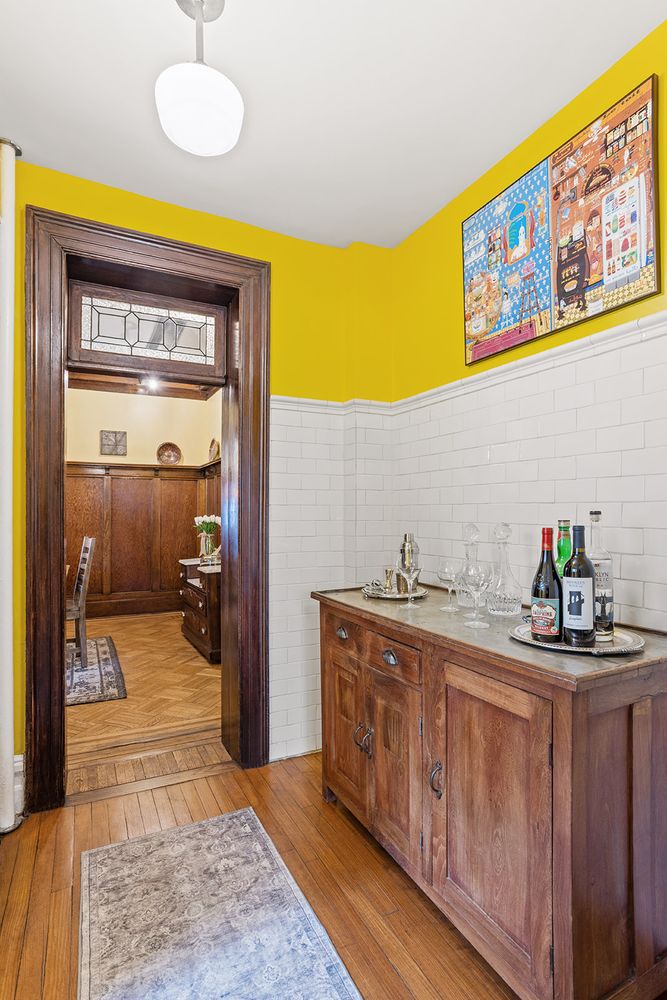 hall with white subway tile and view into