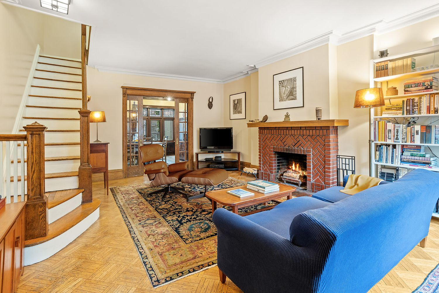 front parlor with brick fireplace, wood floor
