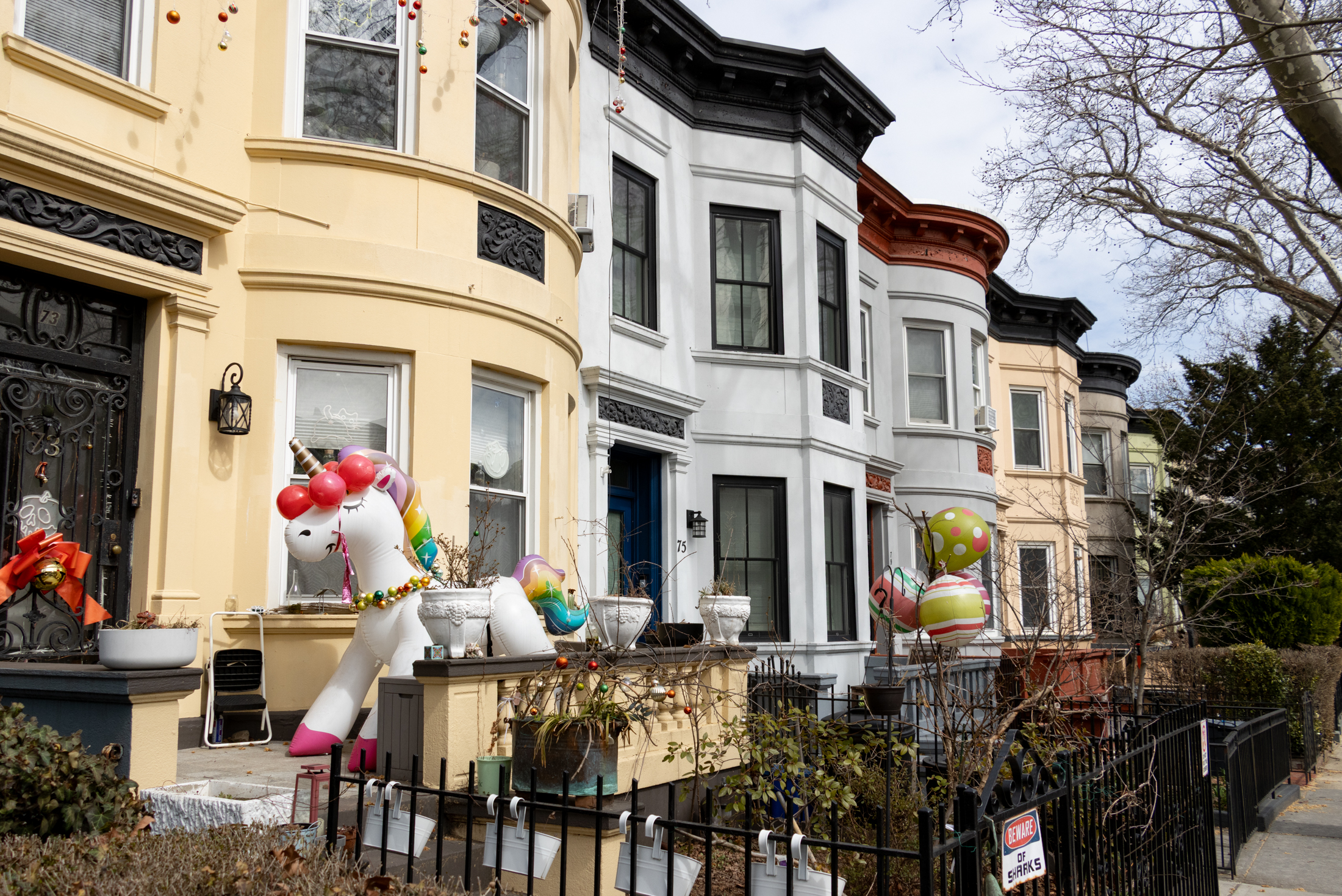 brooklyn - an inflatable unicorn in front of a row house