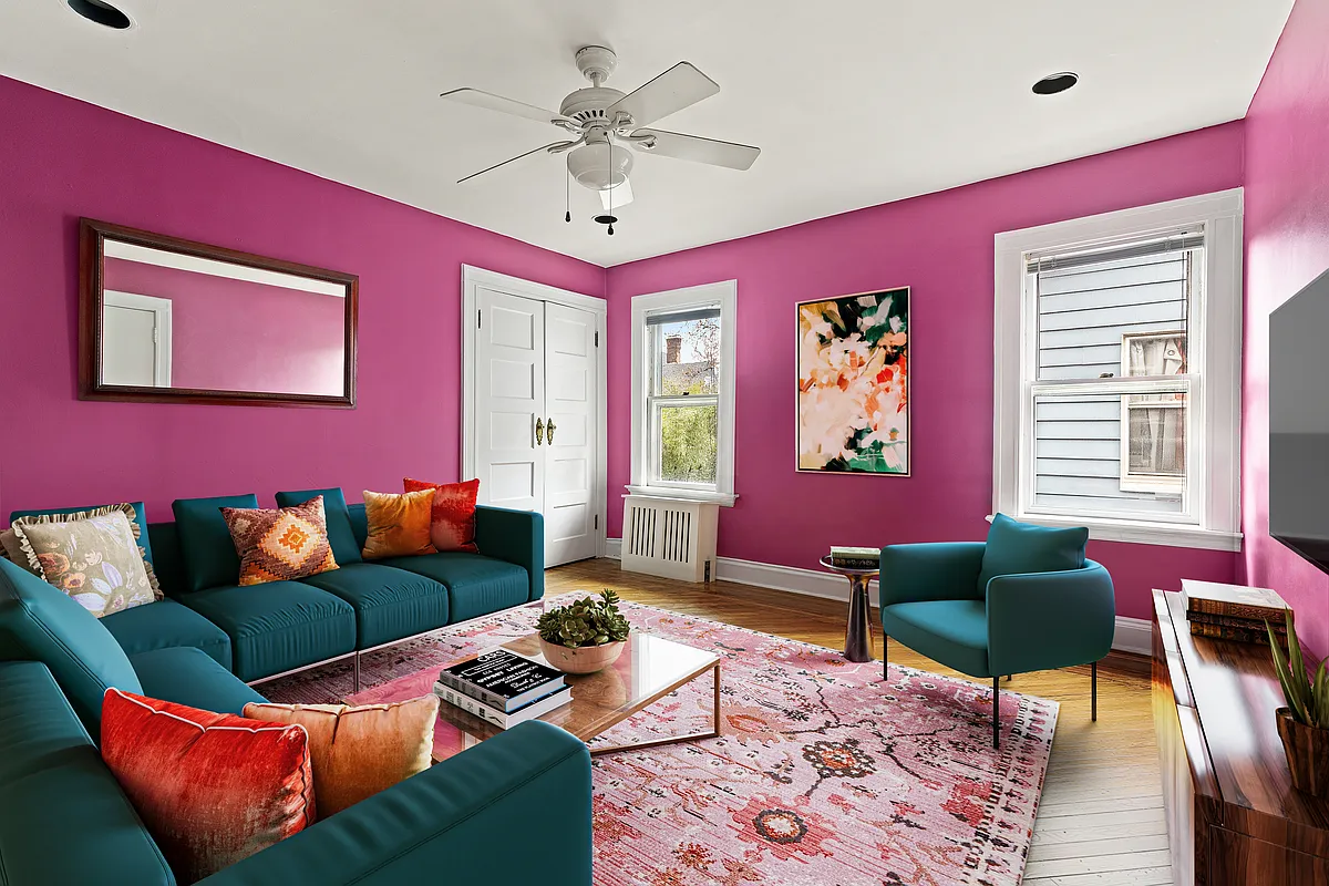 bedroom set up as a living room with bright purple walls