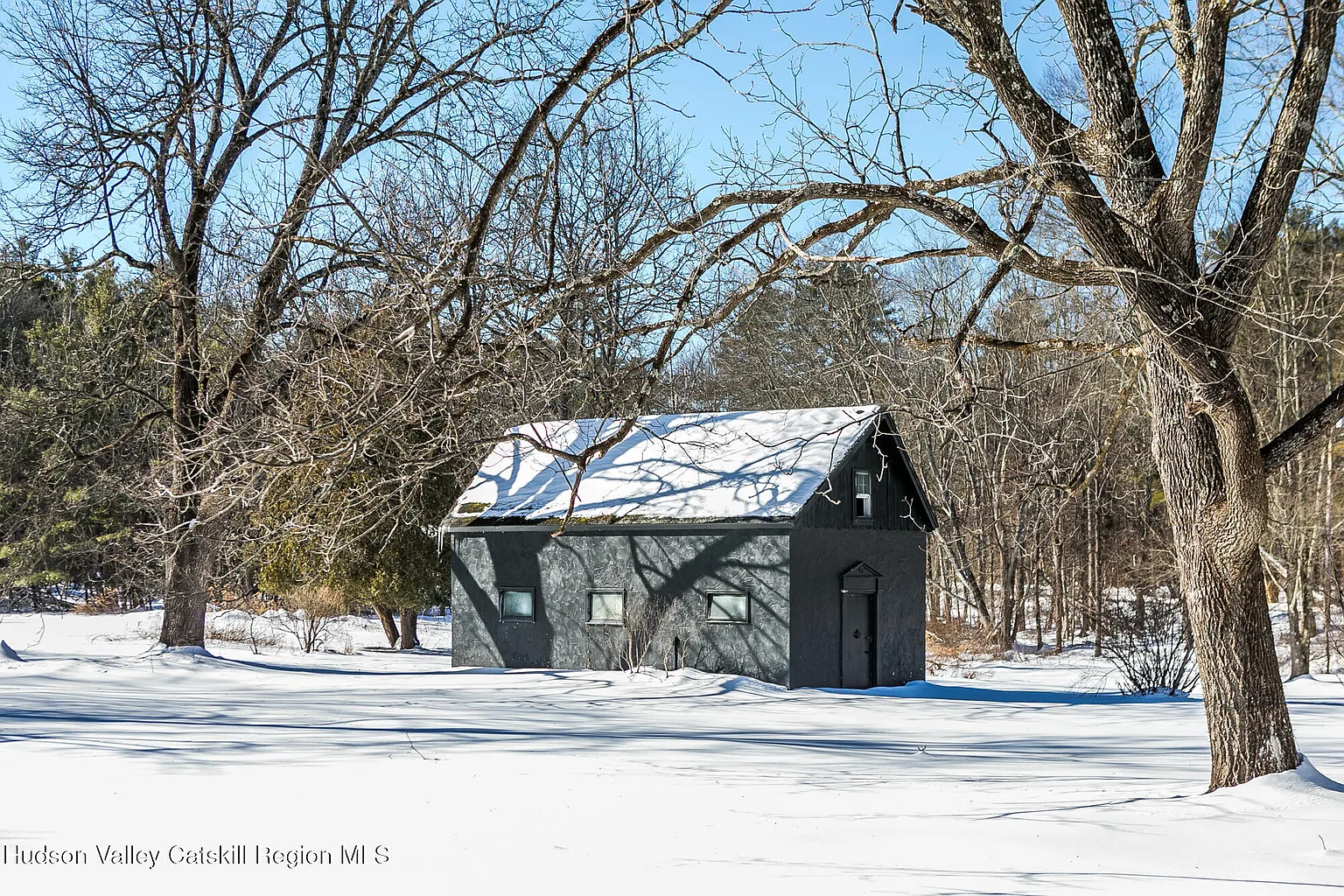 a gray painted outbuilding