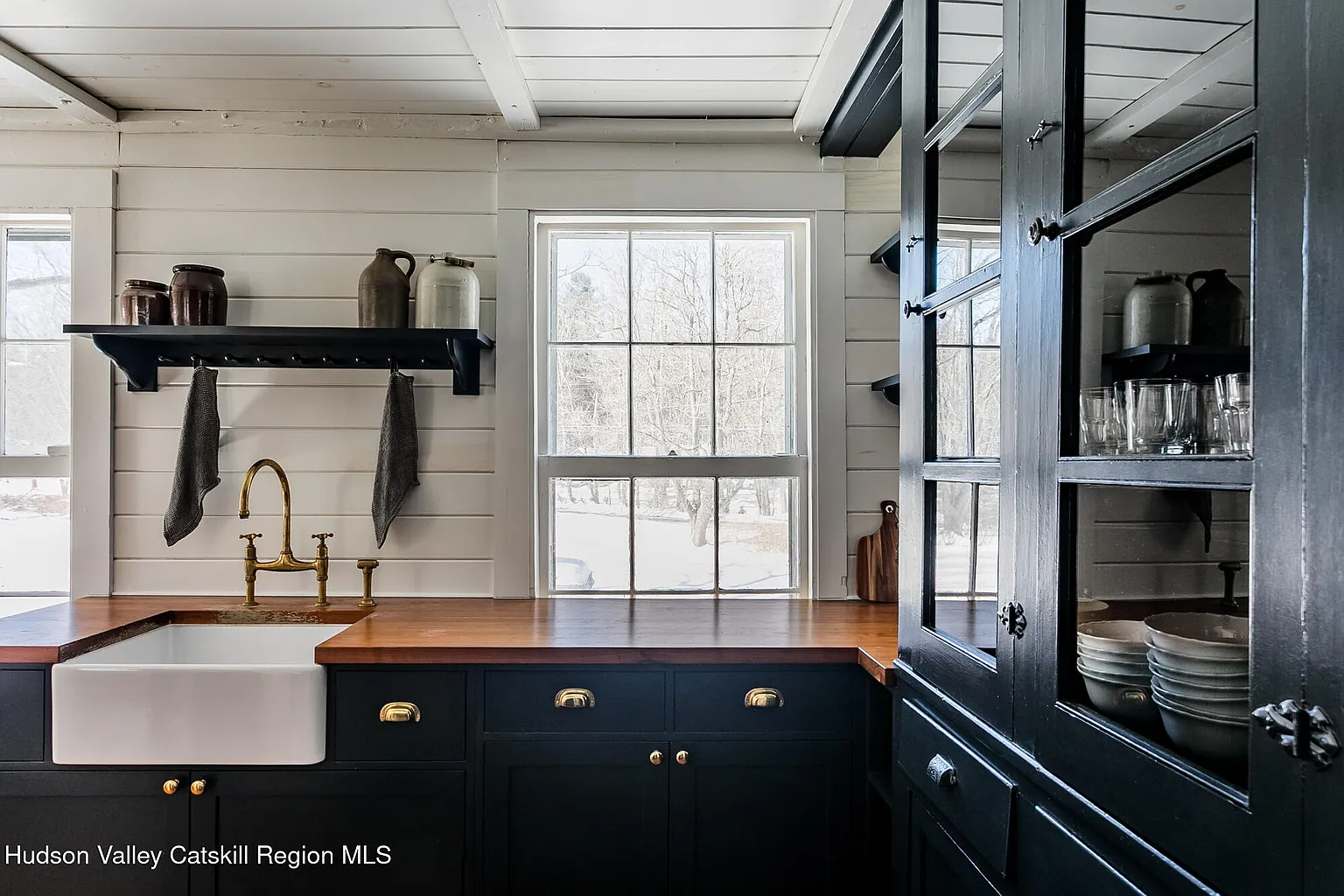 kitchen with dark blue cabinets, some with glass fronts
