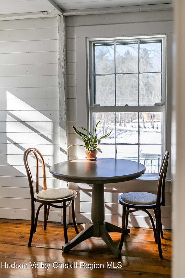 a small table in front of a window in the kitchen