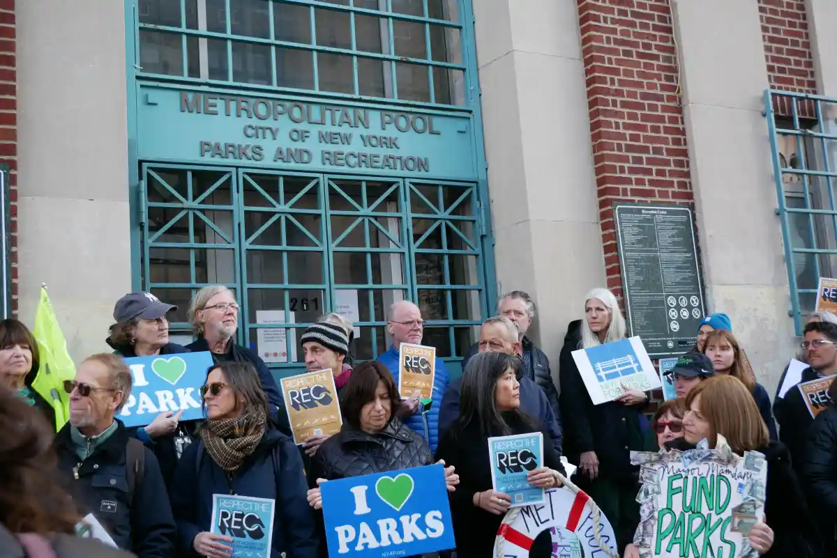 people with signs gathered in front of the building