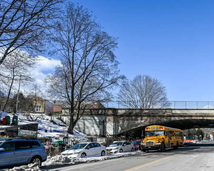 a school bus underneath the bridge