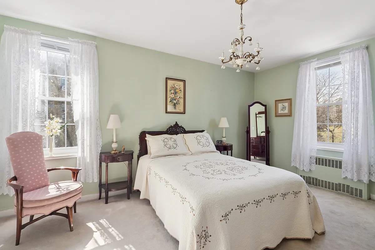 bedroom with cream carpet, two exposures