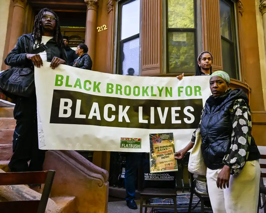 people holding a banner printed with black brooklyn for black lives