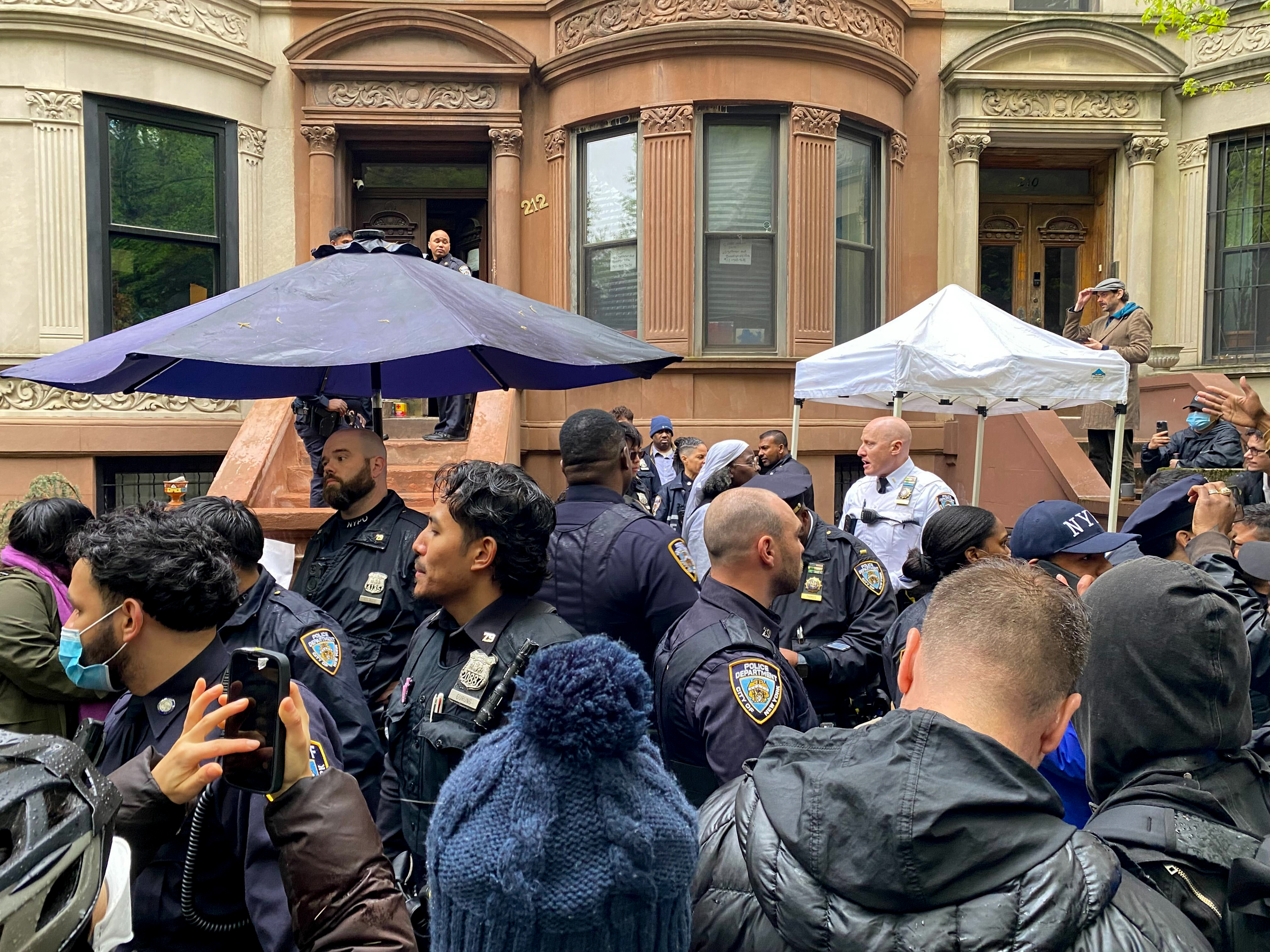 crowd of protestors and nypd officers