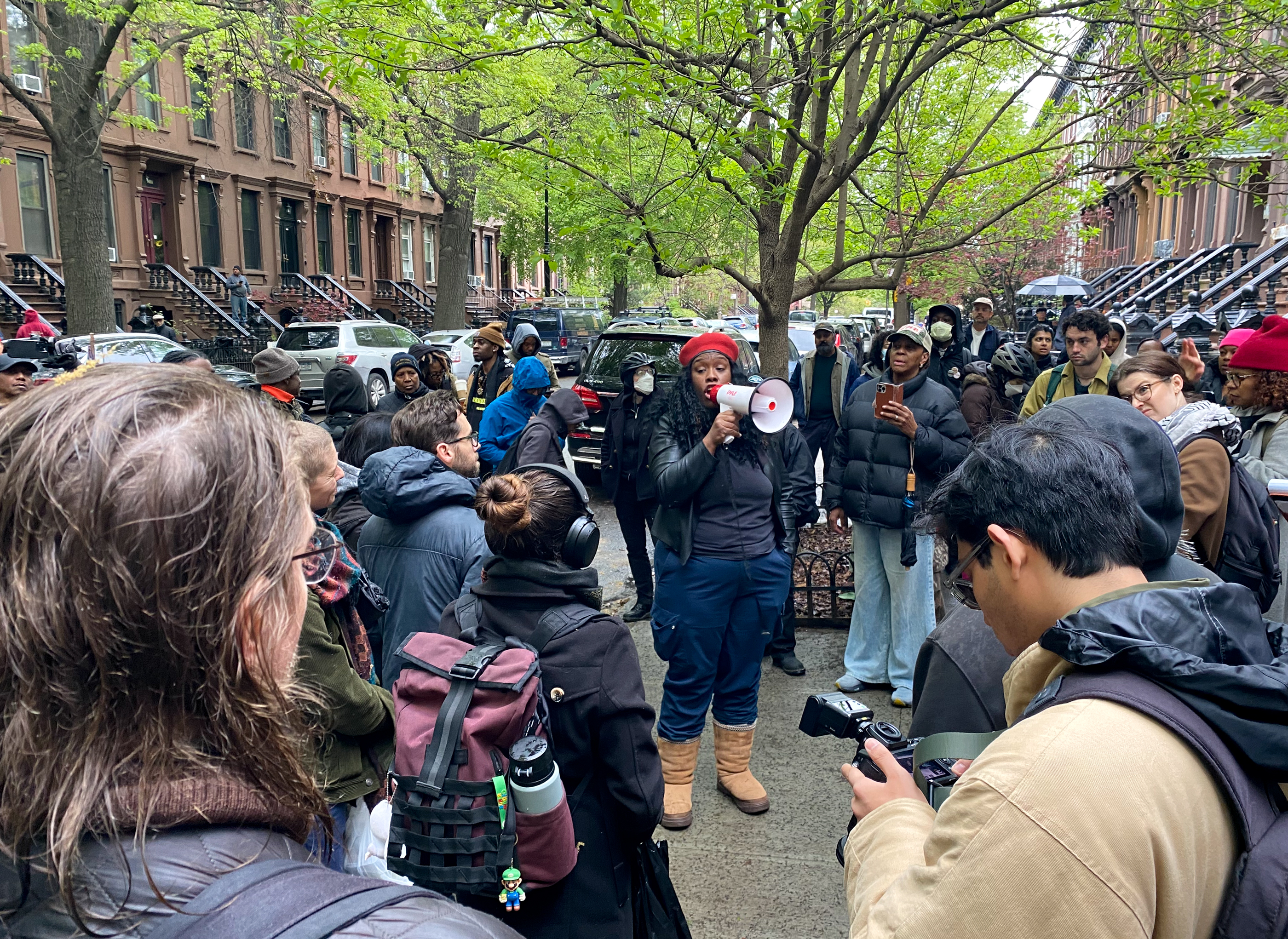 a crowd in front of row houses