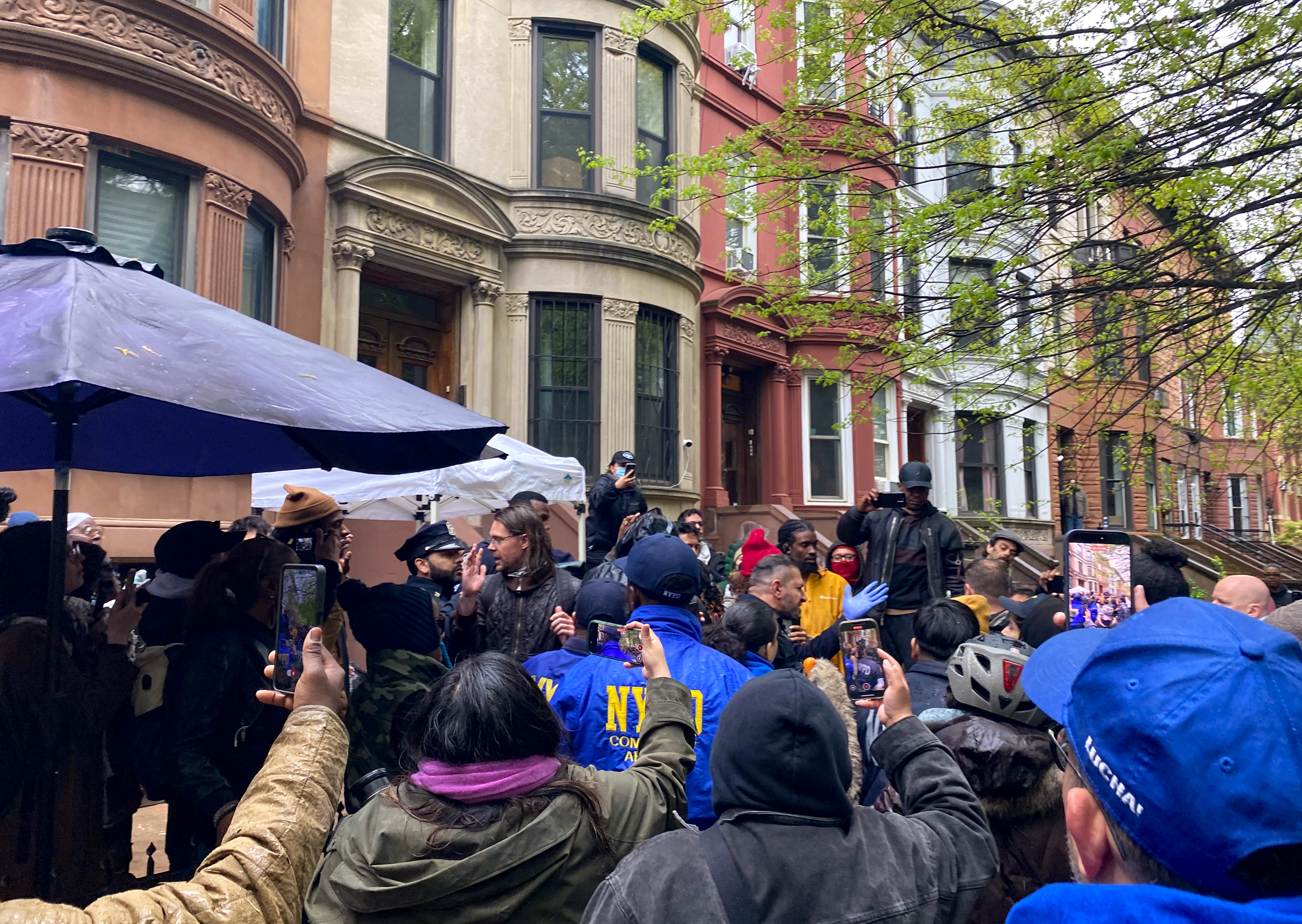 a crowd in front of row houses