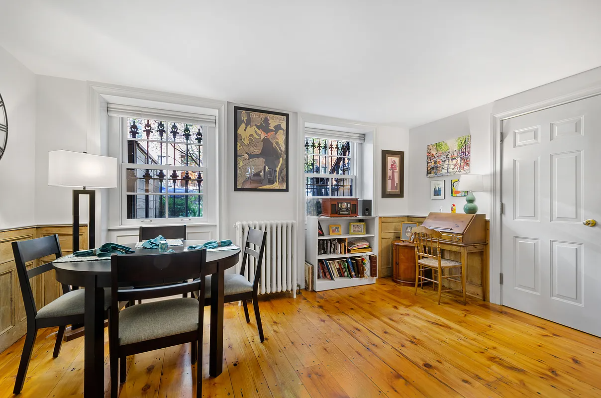 living room with two windows, wood floor, wainscoting