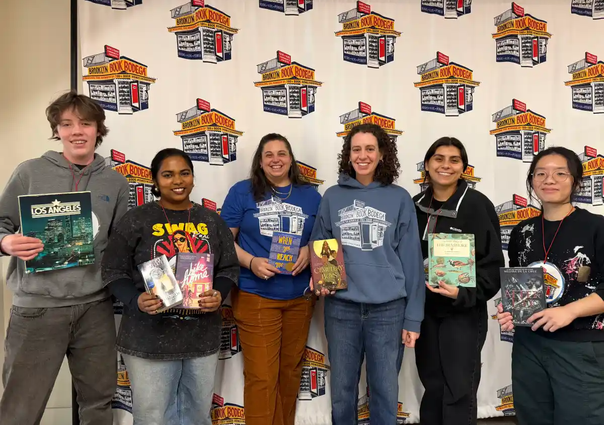 group posing with books