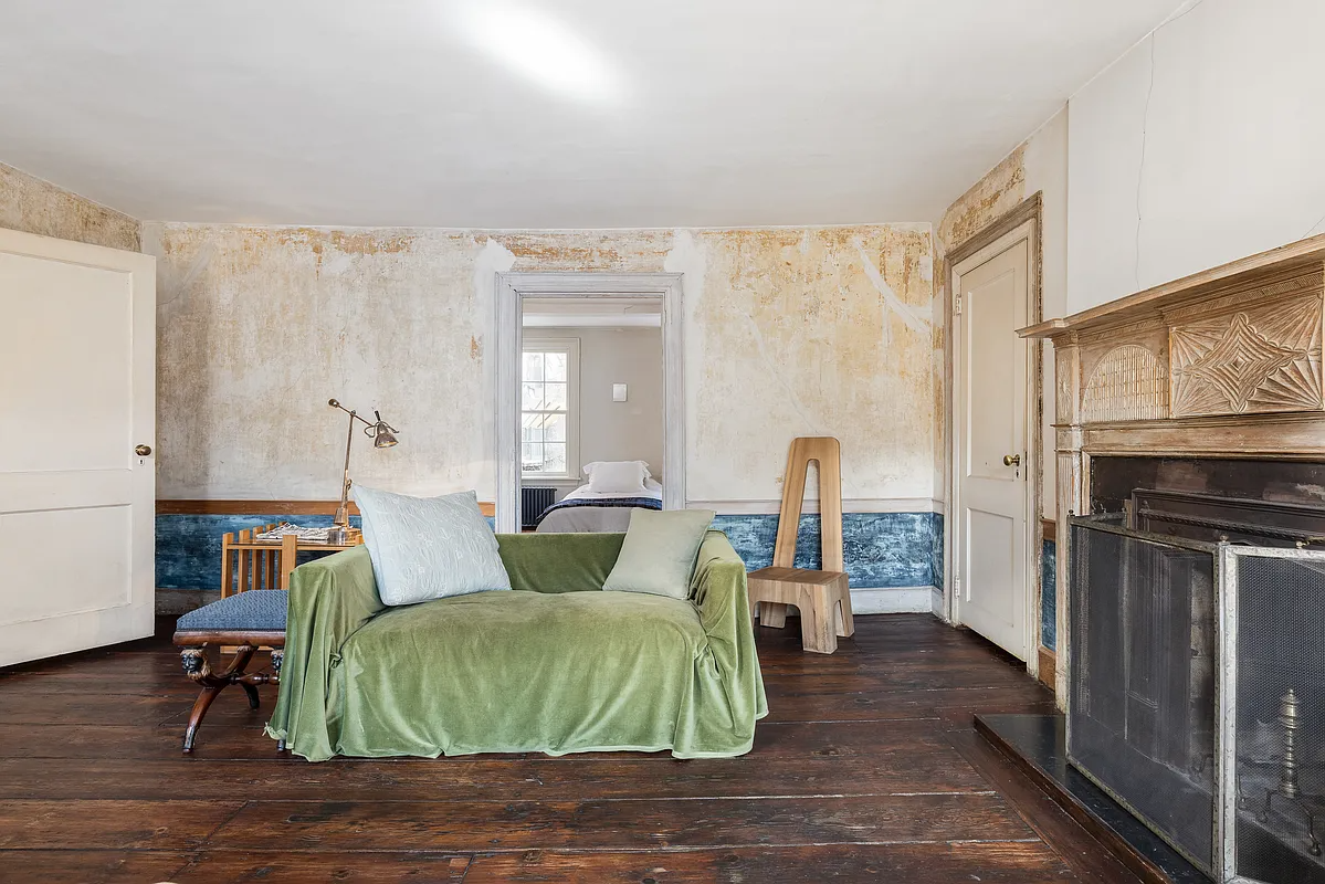 bedroom as office with a wood mantel