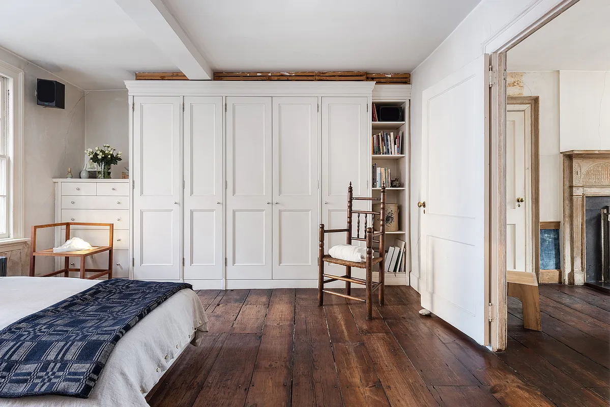 bedroom with built-ins, wood floor