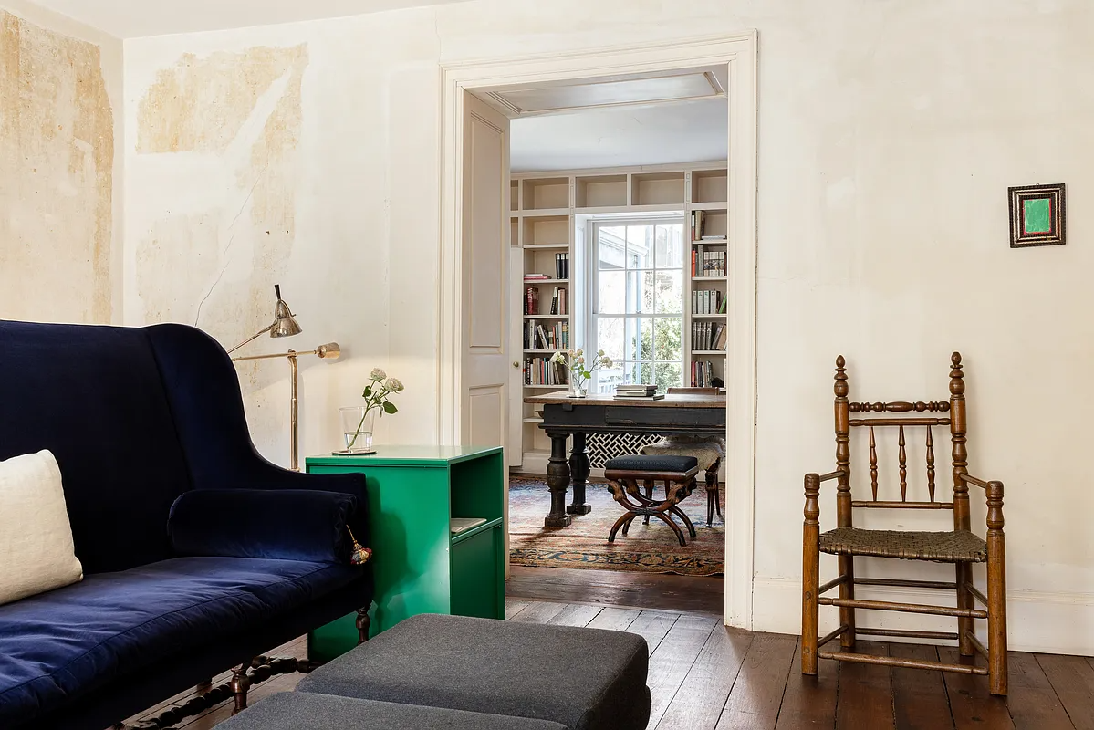 parlor with blue sofa on wood floor