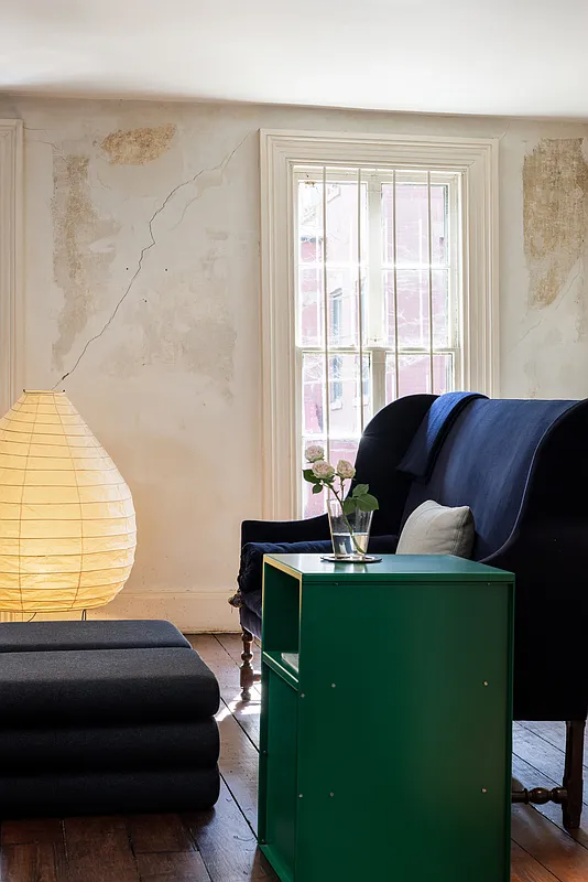 parlor with blue sofa on wood floor