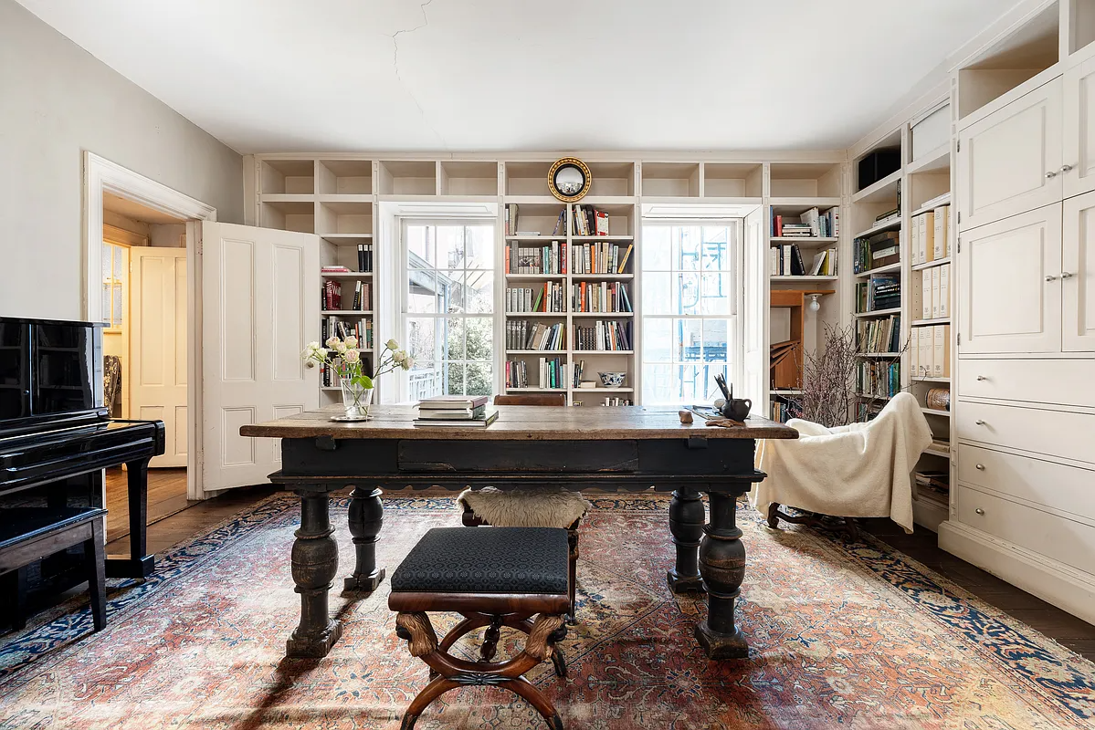parlor with modern bookshelves on two walls