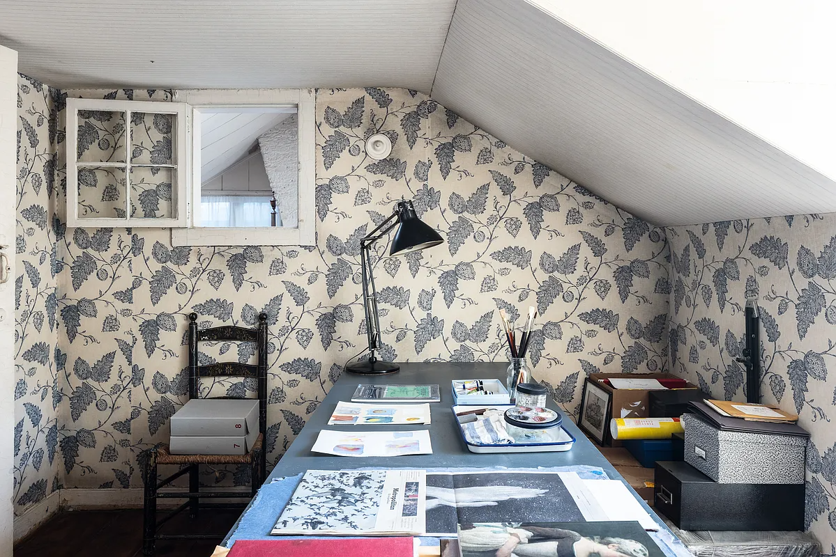work space with blue patterned wallpaper