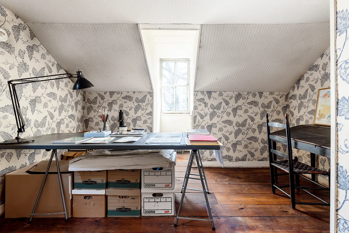 work space with blue patterned wallpaper
