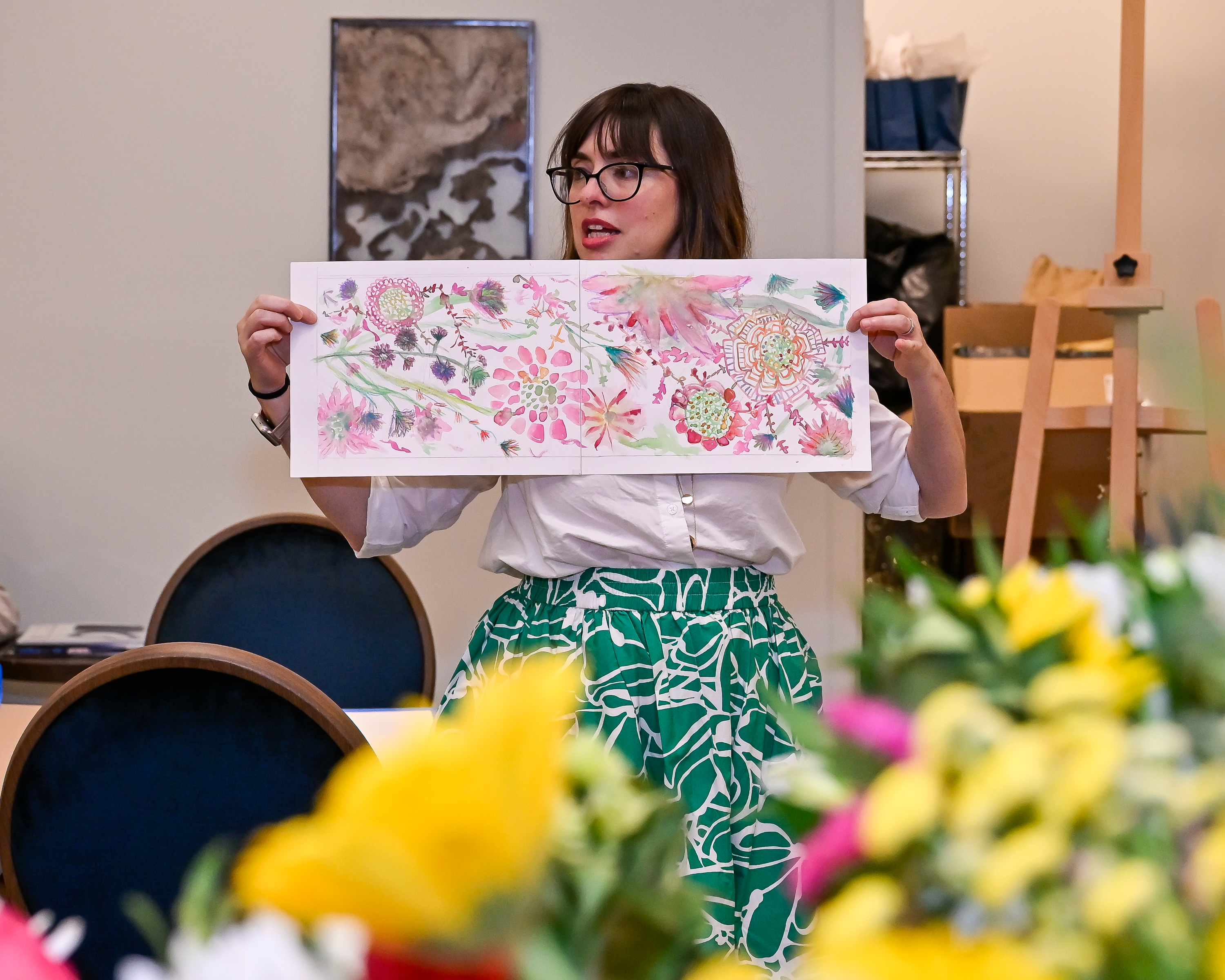 person holding a floral illustration