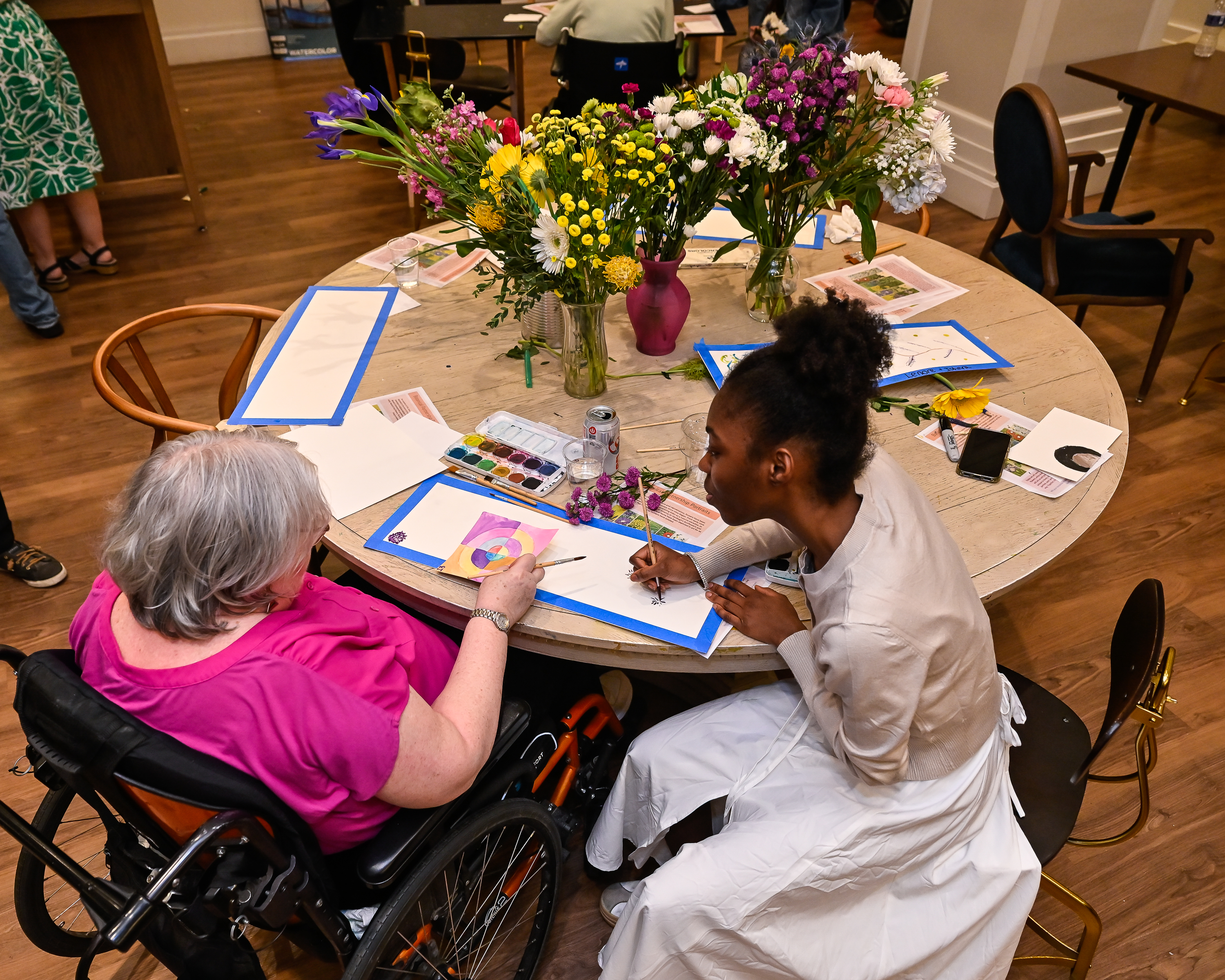 two people working on art